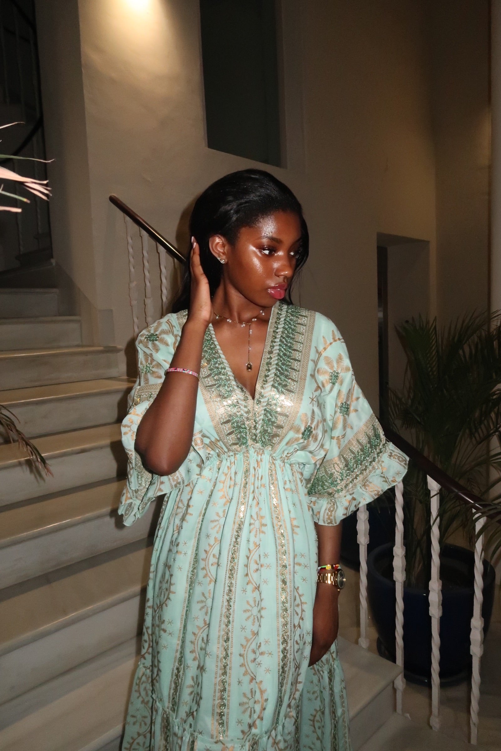 Front view of the turquoise Espera Dress, 100% cotton boho kaftan, shown in an elegant Egyptian courtyard.